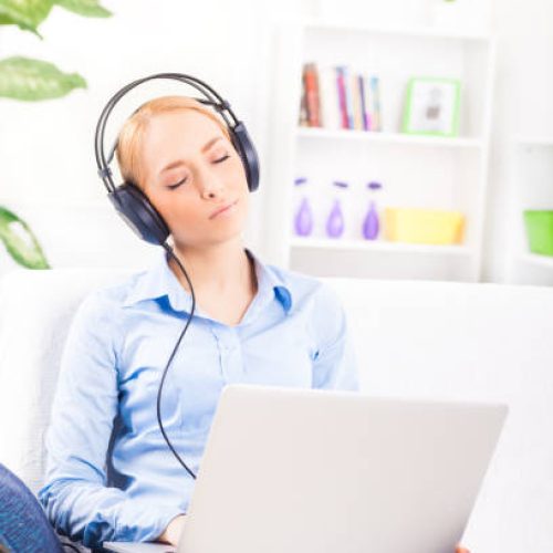 "Beautiful girl with headphones,listening music"